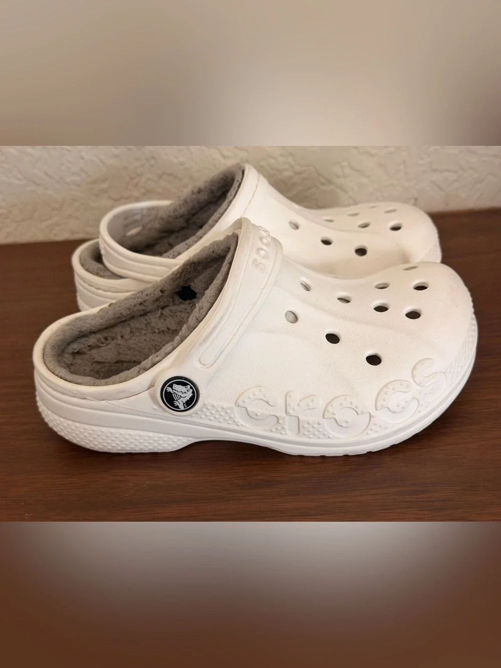 white Crocs Baya Lined Clogs featuring a cozy grey faux-fur lining. C-12